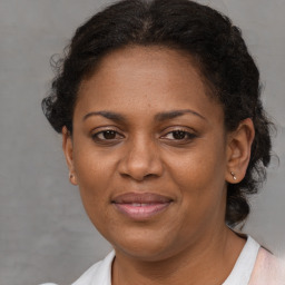 Joyful black adult female with short  brown hair and brown eyes