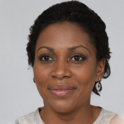 Joyful black adult female with short  brown hair and brown eyes