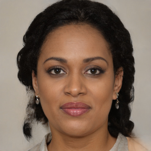 Joyful black young-adult female with medium  brown hair and brown eyes