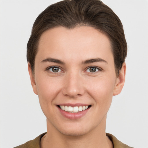 Joyful white young-adult female with short  brown hair and brown eyes