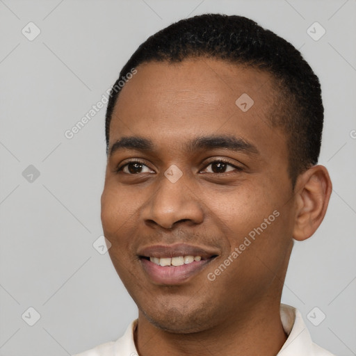 Joyful black young-adult male with short  black hair and brown eyes