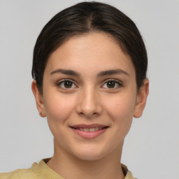 Joyful white young-adult female with short  brown hair and brown eyes