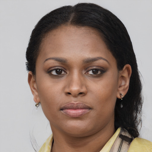 Joyful black young-adult female with medium  brown hair and brown eyes