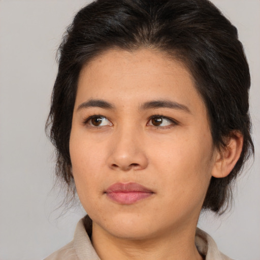Joyful asian young-adult female with medium  brown hair and brown eyes