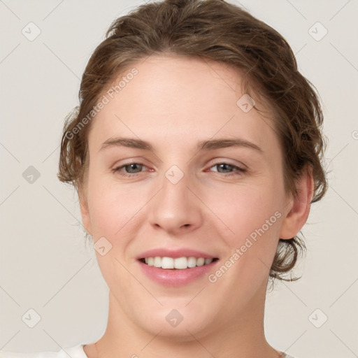 Joyful white young-adult female with medium  brown hair and green eyes