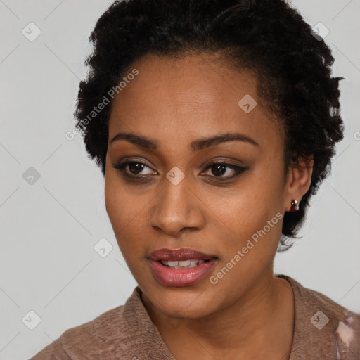 Joyful black young-adult female with short  black hair and brown eyes