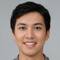 Joyful asian young-adult male with short  black hair and brown eyes