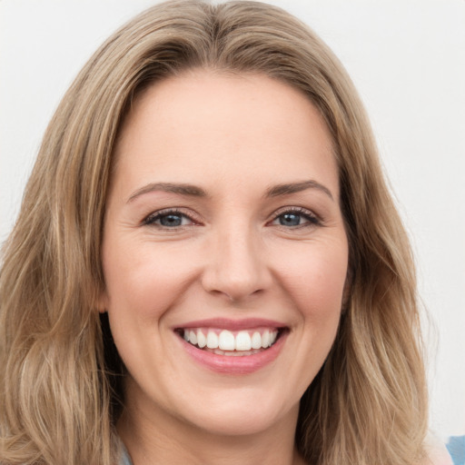 Joyful white young-adult female with long  brown hair and green eyes