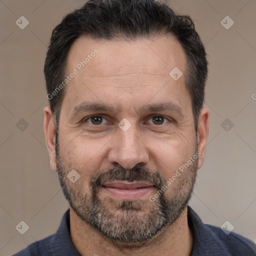 Joyful white adult male with short  black hair and brown eyes