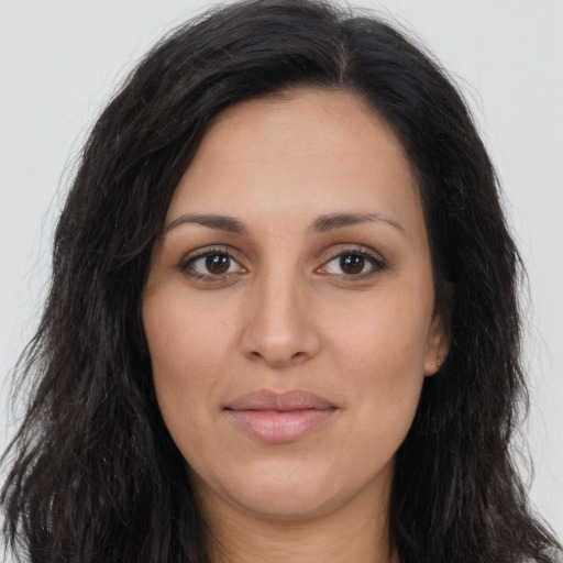 Joyful latino young-adult female with long  brown hair and brown eyes