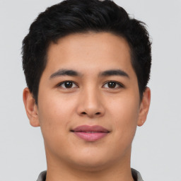 Joyful asian young-adult male with short  brown hair and brown eyes