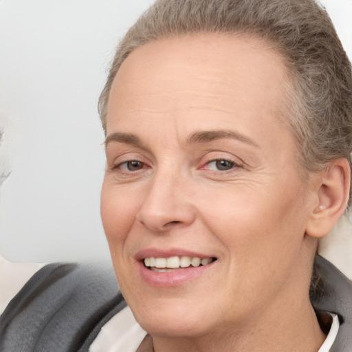 Joyful white adult female with short  brown hair and brown eyes