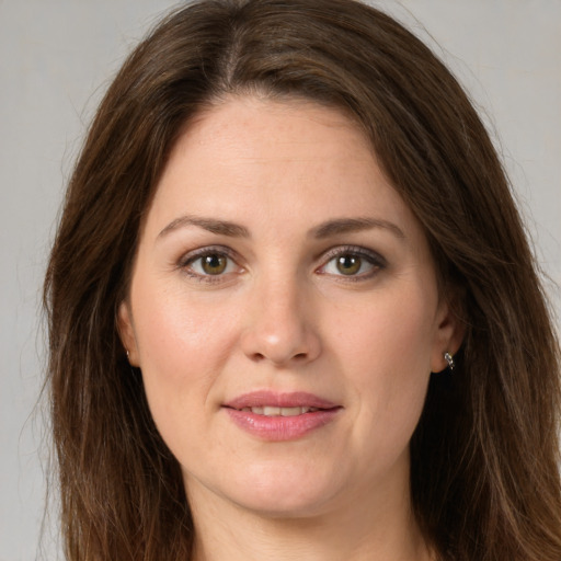 Joyful white young-adult female with long  brown hair and green eyes