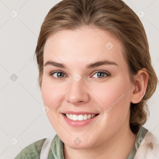 Joyful white young-adult female with medium  brown hair and blue eyes