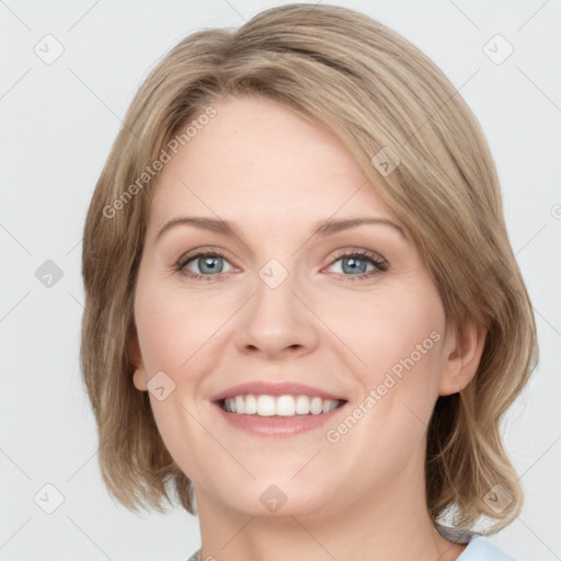 Joyful white young-adult female with medium  brown hair and green eyes