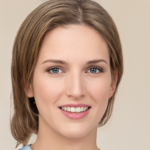 Joyful white young-adult female with medium  brown hair and green eyes