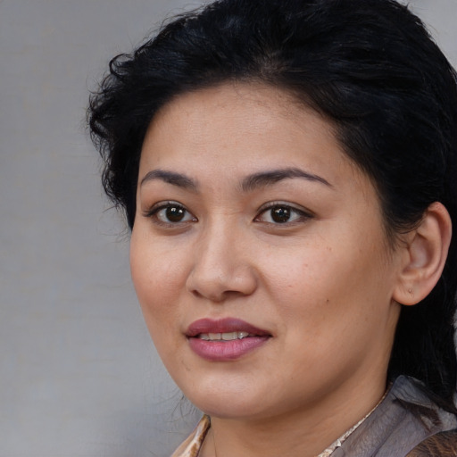 Joyful white young-adult female with medium  black hair and brown eyes