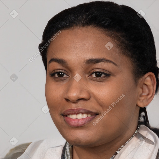 Joyful black young-adult female with short  black hair and brown eyes