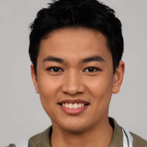 Joyful asian young-adult male with short  black hair and brown eyes