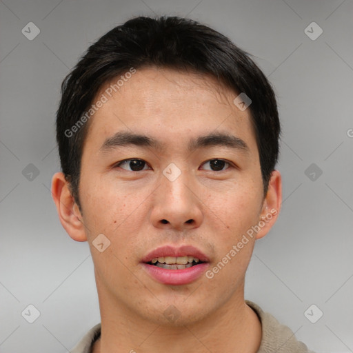 Joyful asian young-adult male with short  brown hair and brown eyes