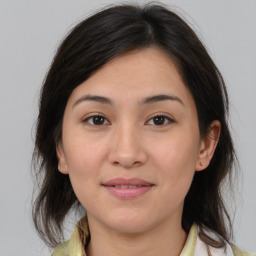 Joyful latino young-adult female with medium  brown hair and brown eyes