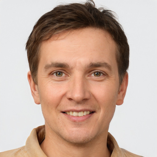 Joyful white adult male with short  brown hair and grey eyes