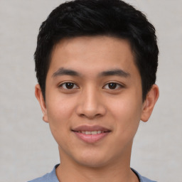 Joyful asian young-adult male with short  black hair and brown eyes