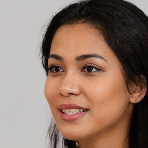 Joyful white young-adult female with long  black hair and brown eyes