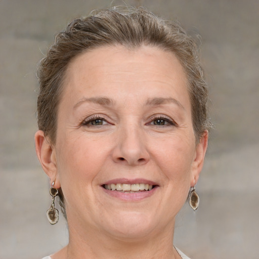 Joyful white adult female with short  brown hair and grey eyes