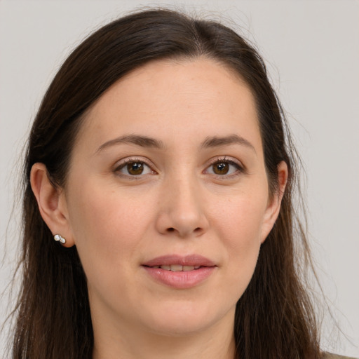 Joyful white young-adult female with long  brown hair and brown eyes