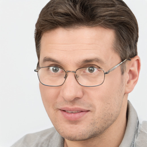 Joyful white adult male with short  brown hair and brown eyes