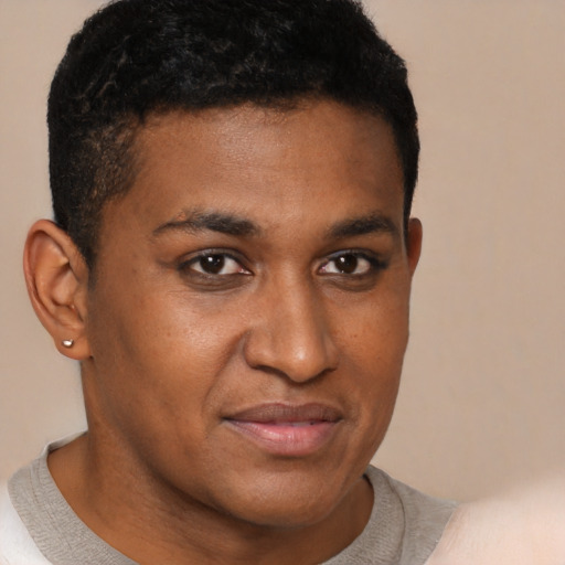 Joyful black young-adult male with short  brown hair and brown eyes