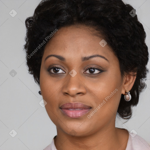 Joyful black young-adult female with long  black hair and brown eyes