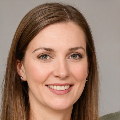 Joyful white young-adult female with long  brown hair and green eyes