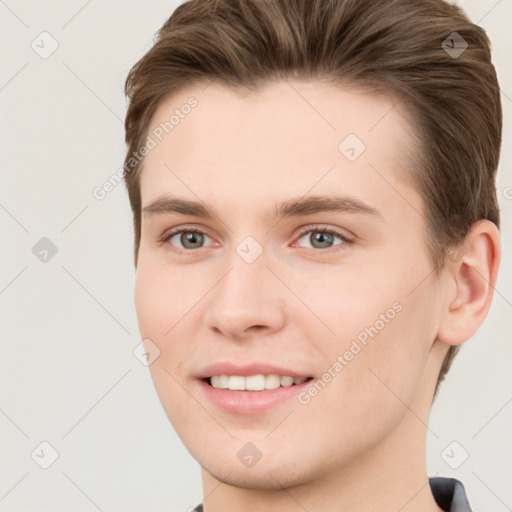 Joyful white young-adult female with short  brown hair and grey eyes