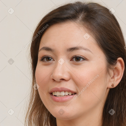 Joyful white young-adult female with long  brown hair and brown eyes