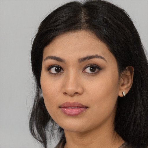 Joyful asian young-adult female with long  black hair and brown eyes