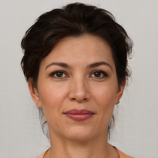 Joyful white adult female with medium  brown hair and brown eyes
