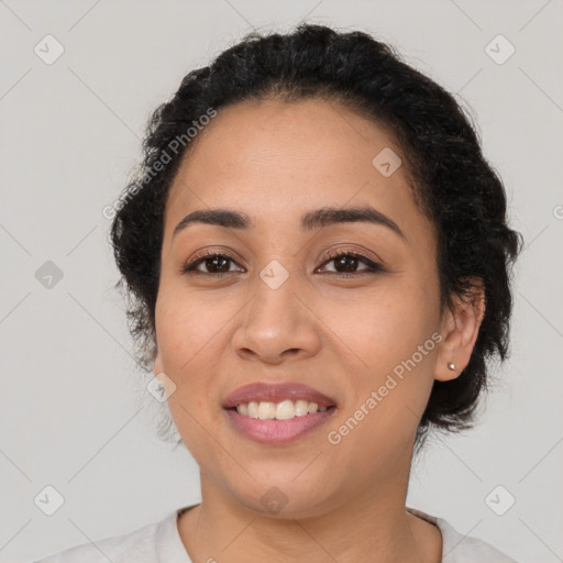 Joyful latino young-adult female with short  black hair and brown eyes