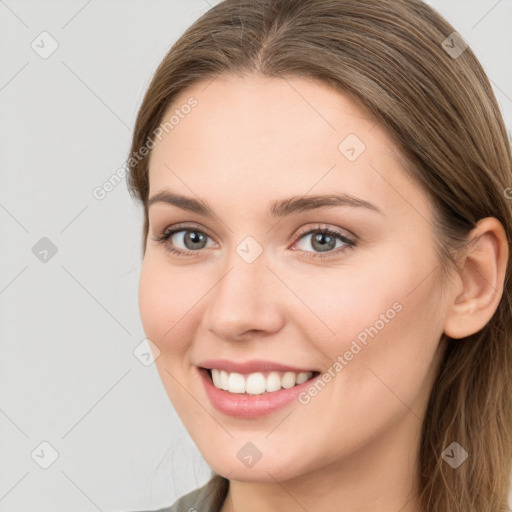 Joyful white young-adult female with long  brown hair and grey eyes