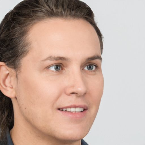 Joyful white young-adult male with medium  brown hair and brown eyes