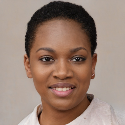 Joyful black young-adult female with short  brown hair and brown eyes