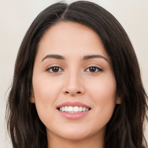 Joyful white young-adult female with long  brown hair and brown eyes