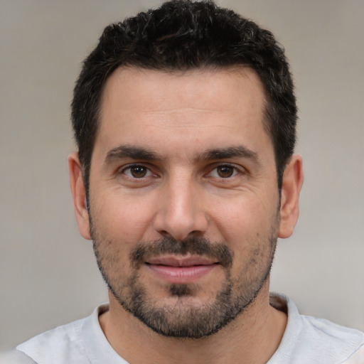 Joyful white young-adult male with short  black hair and brown eyes