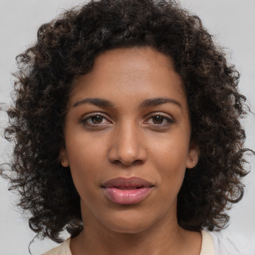 Joyful black young-adult female with medium  brown hair and brown eyes