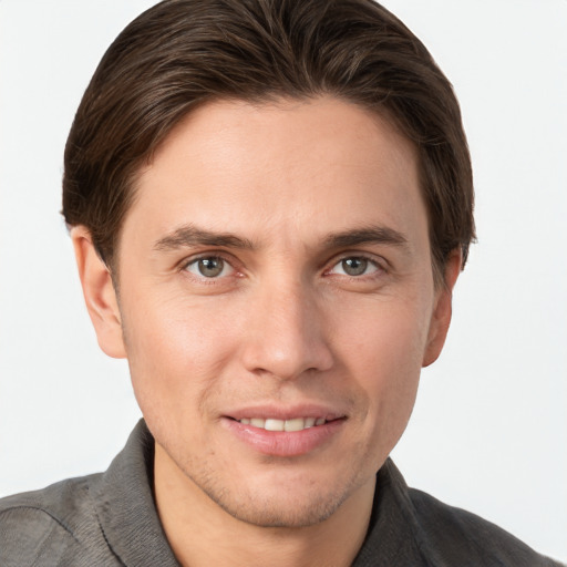 Joyful white young-adult male with short  brown hair and grey eyes