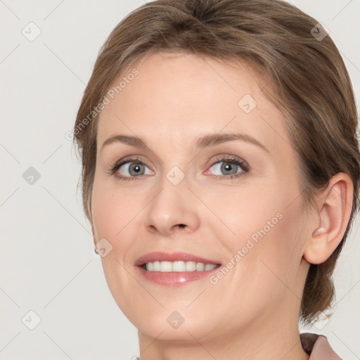 Joyful white young-adult female with medium  brown hair and blue eyes