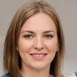 Joyful white young-adult female with medium  brown hair and grey eyes