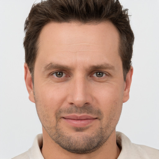 Joyful white adult male with short  brown hair and brown eyes