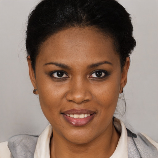 Joyful black young-adult female with short  brown hair and brown eyes